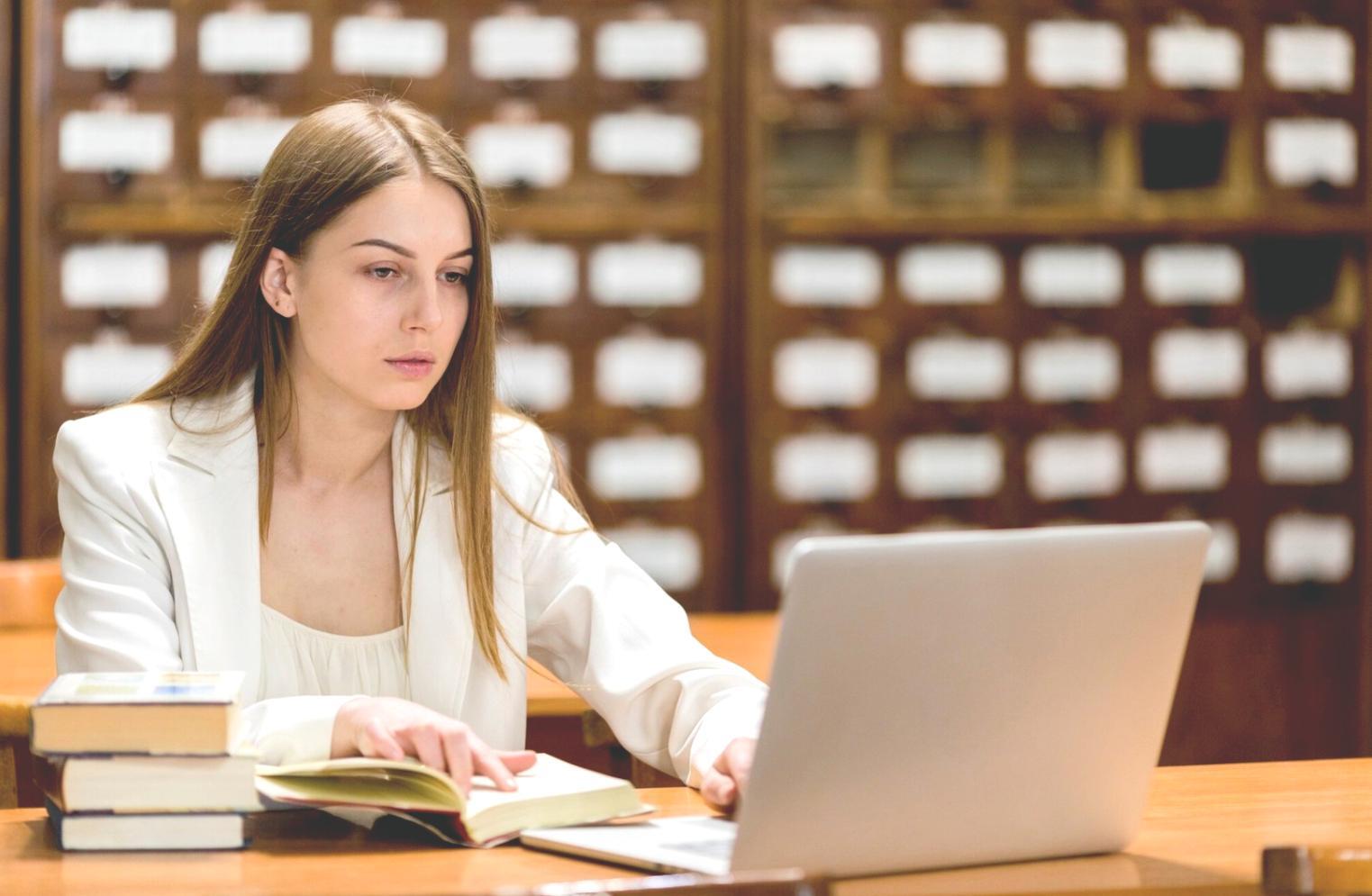 Business owner reviewing financial statements and reports on desk with calculator and charts